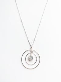 danielle long silver necklace. 2 halos around a crystal pendent.