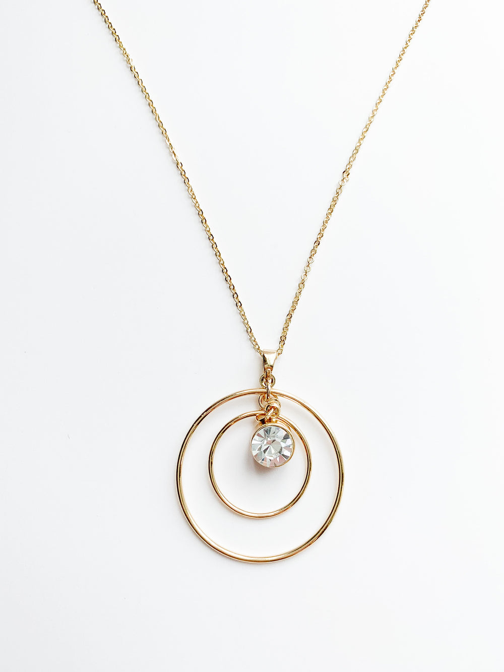 Danielle long gold necklace with 2 halos around a crystal pendent.