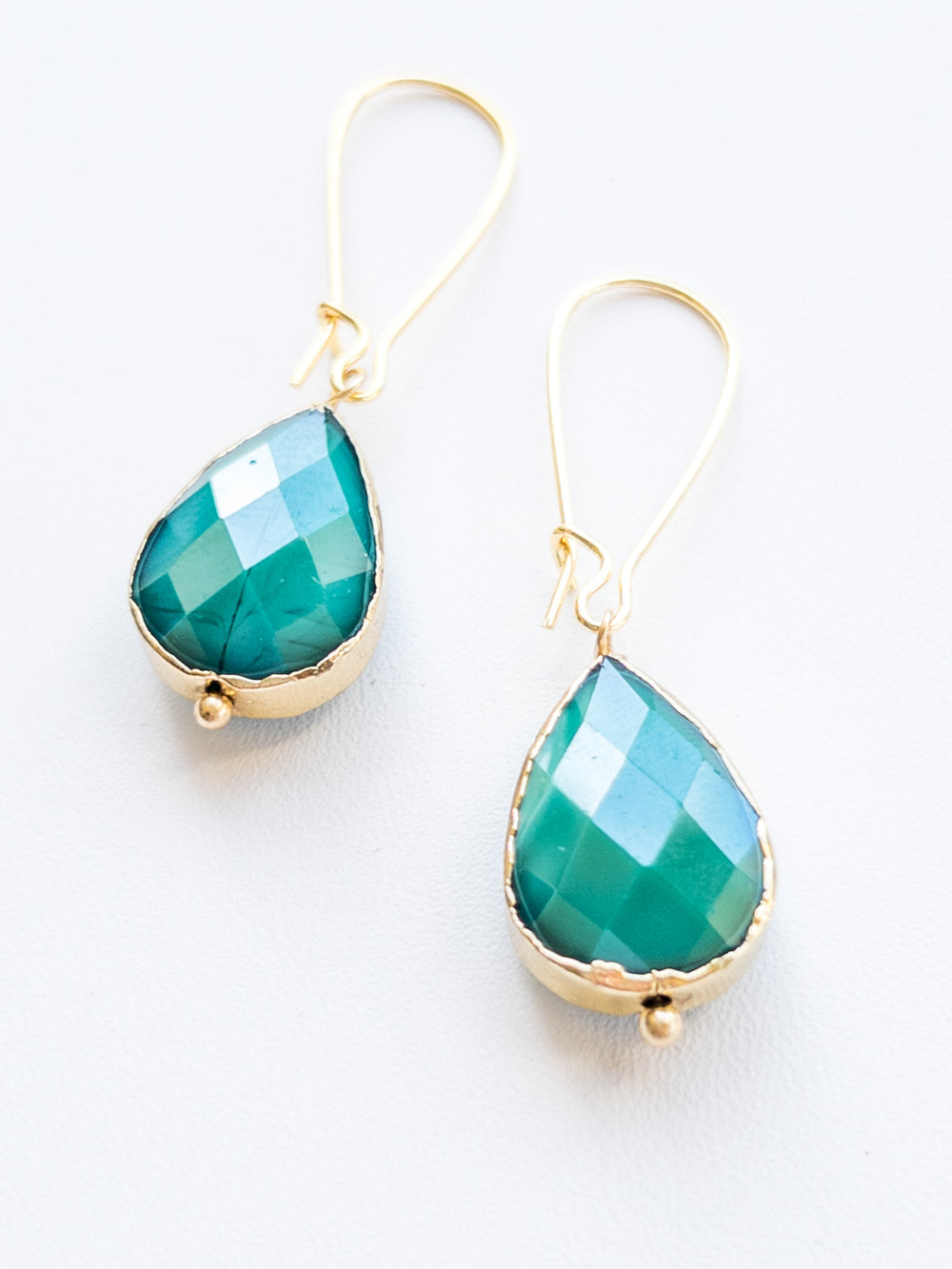 Emerald green and gold dangle tear drop handmade nickel free earrings flat lay