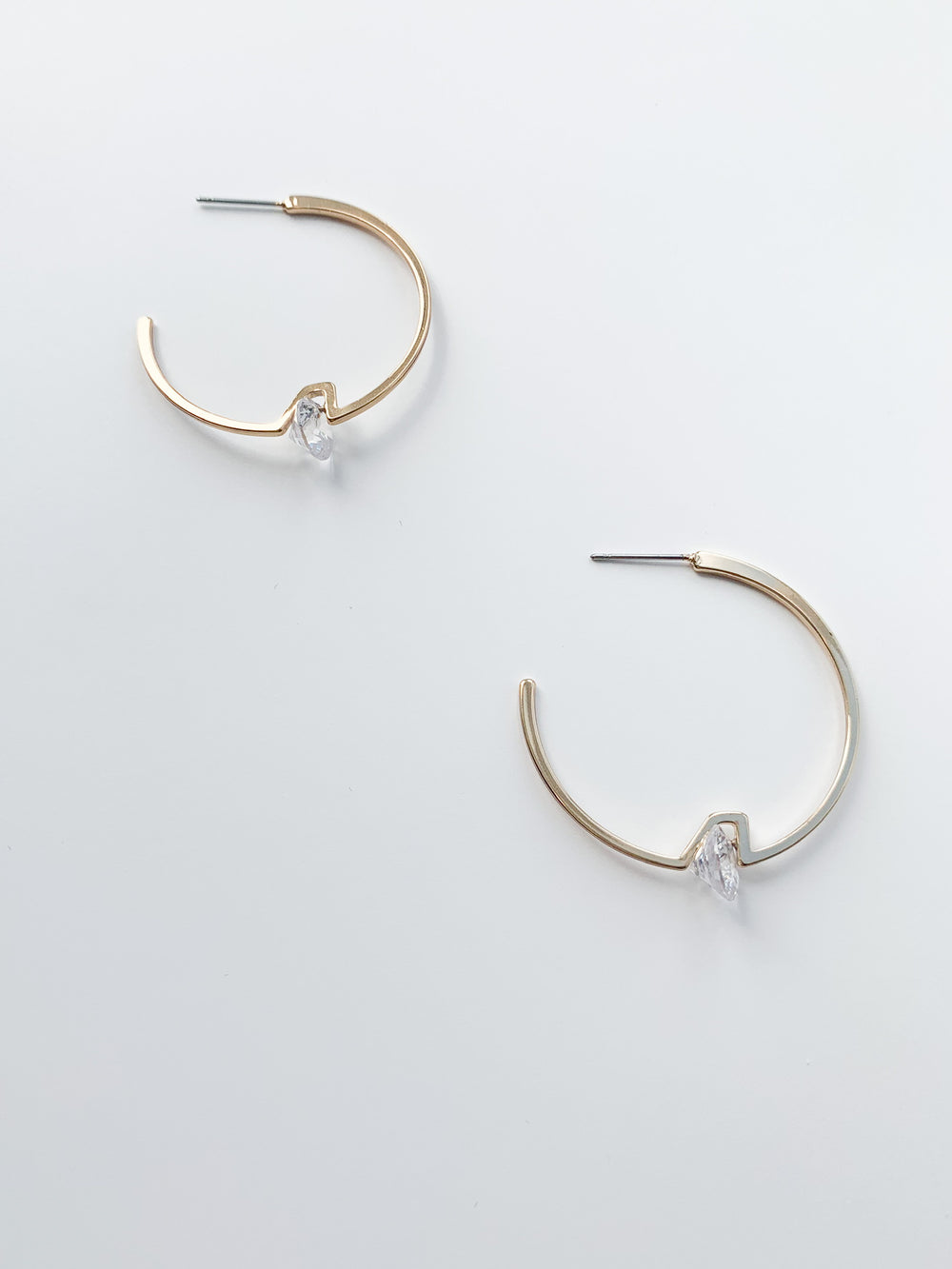Gold Sammy Hoop earrings with clear crystal accent at bottom center of hoop
