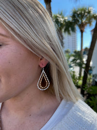 Lara Earrings shown on model. Dangle earrings with a silver and gold hanging detail